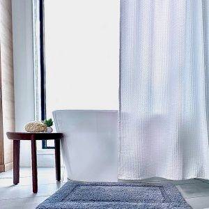 Stevens and Olivier white waffle shower curtain and tufted 100% cotton bathroom mat in luxury spa bathroom